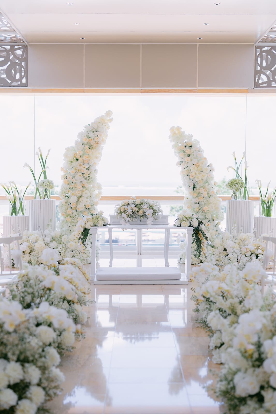 white floral ceremony aisle and altar styling