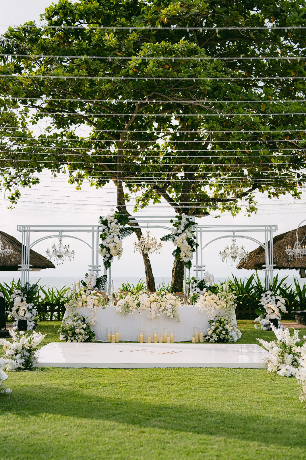 seaside ceremony canopy with white florals