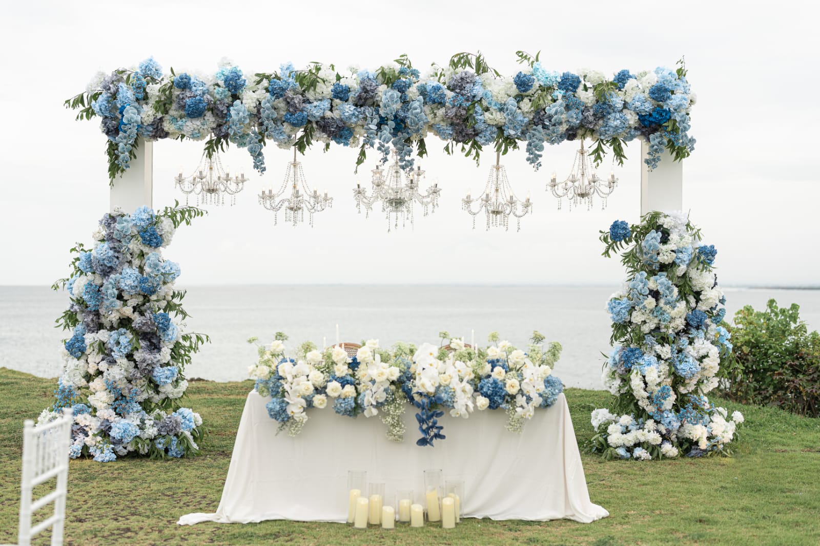 blue and white floral ceremony backdrop by the sea