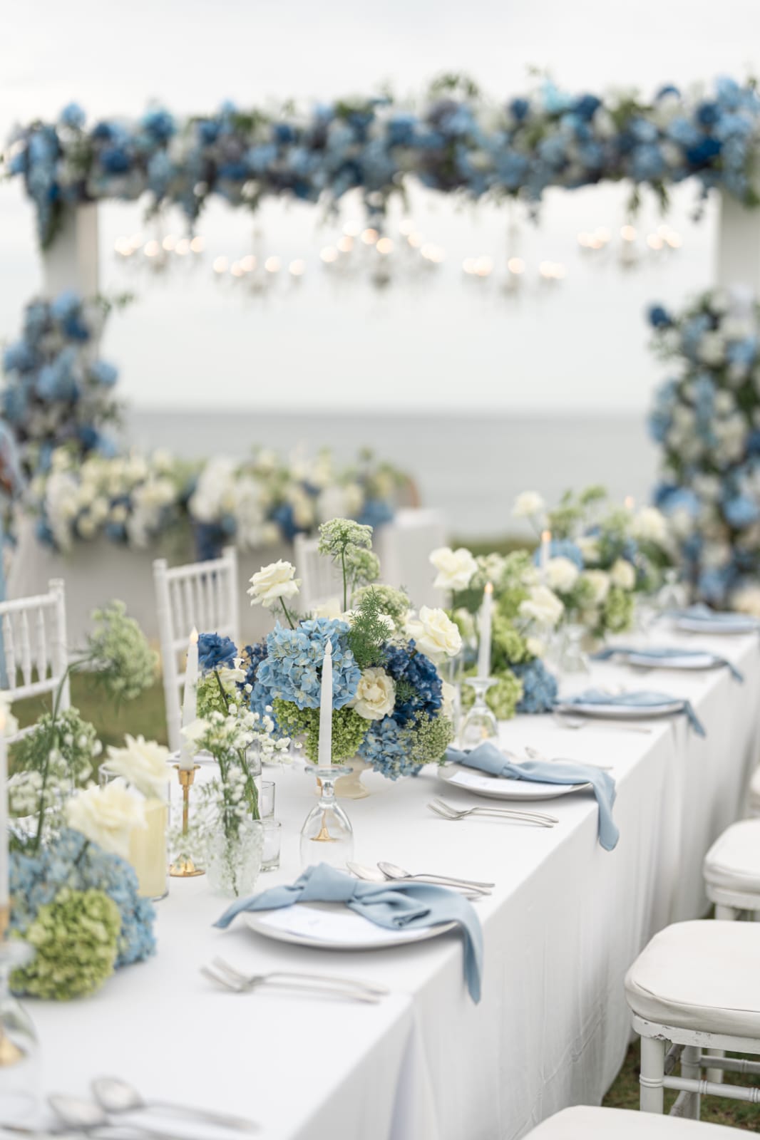 blue and white reception table with floral styling