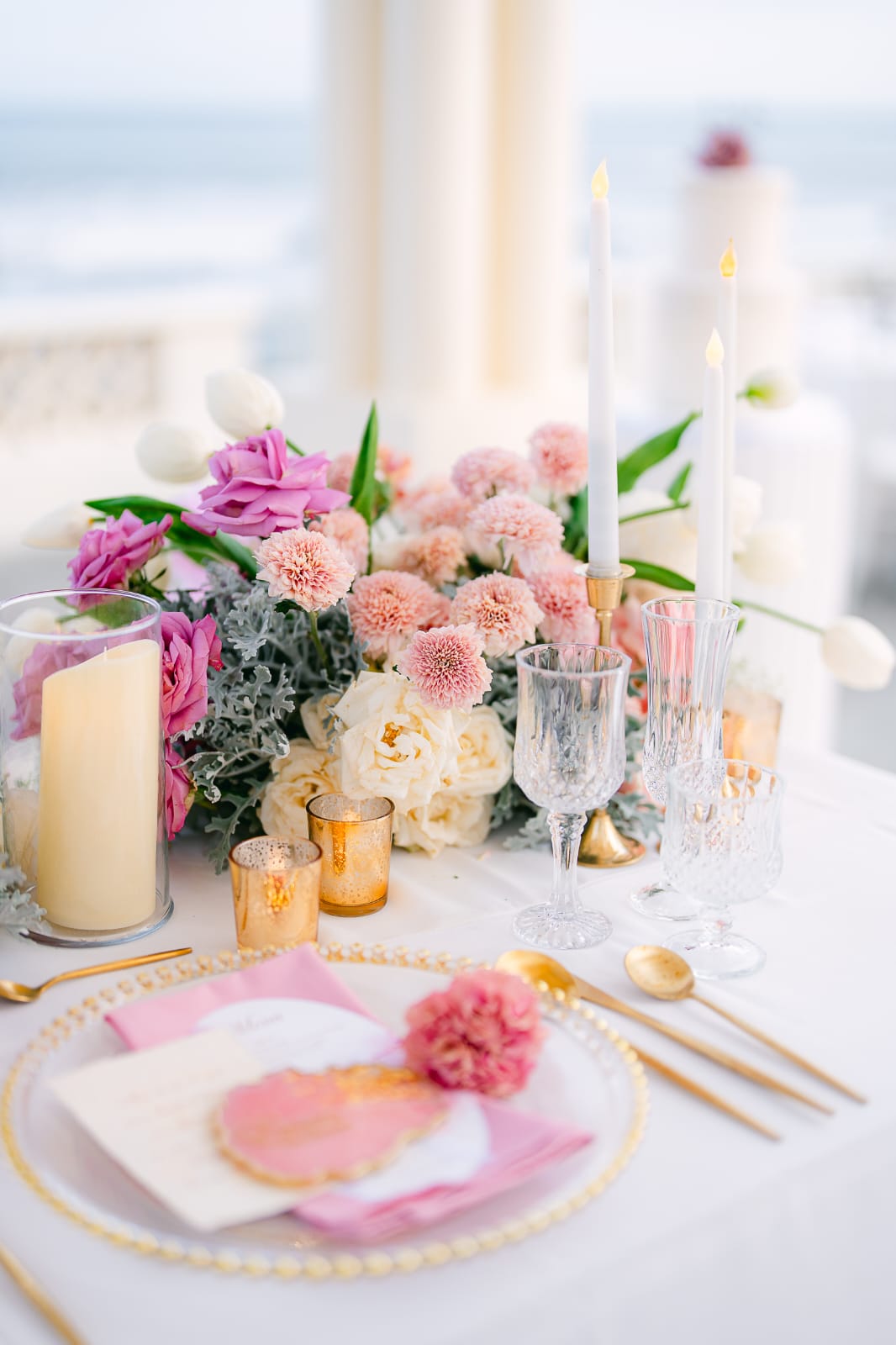 pink reception tablescape detail with floral centerpiece and candles